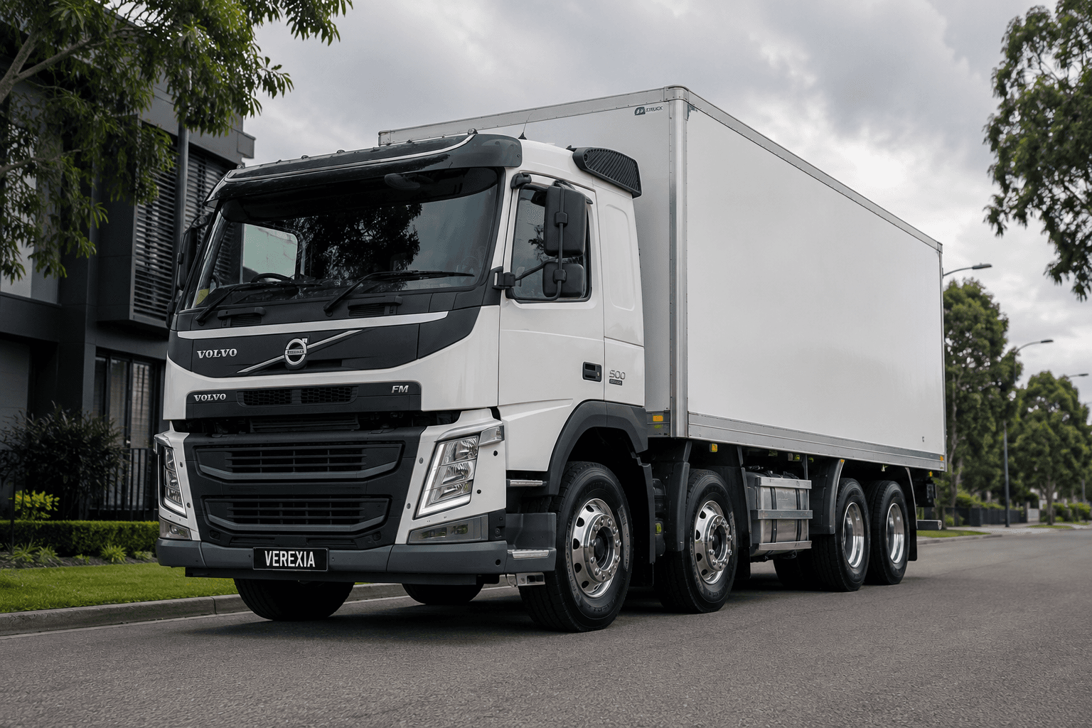 White Volvo FM rigid truck with a Verexia number plate, on a suburban street